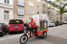 Auf kurzen Wegen schneller als jedes Auto: Anne Effenberger mit dem Lastenrad im Univiertel.
<br />(49x32 cm)<br />Foto: Michael Zapf